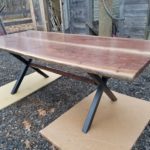 A table with two chairs and a wooden top